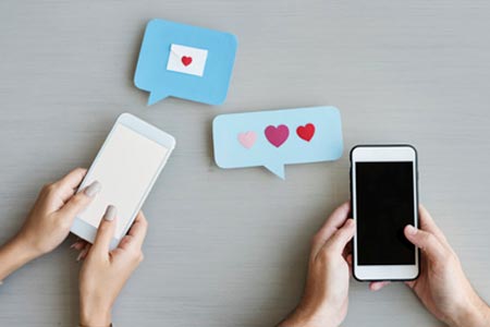 duas pessoas em celulares trocando conteúdos de amor -Como divulgar o trabalho de terapeuta de forma humanizada