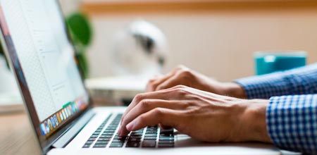 homem digitando em teclado de computador