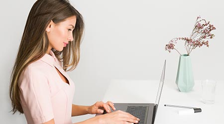 terapeuta em mesa usando laptop lendo dicas para divulgar terapia holística